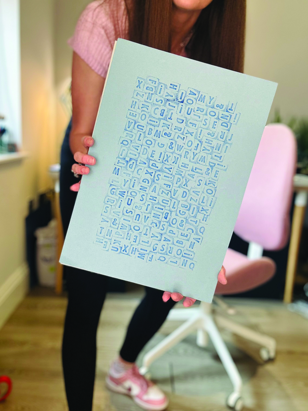 Lady holding some typography artwork